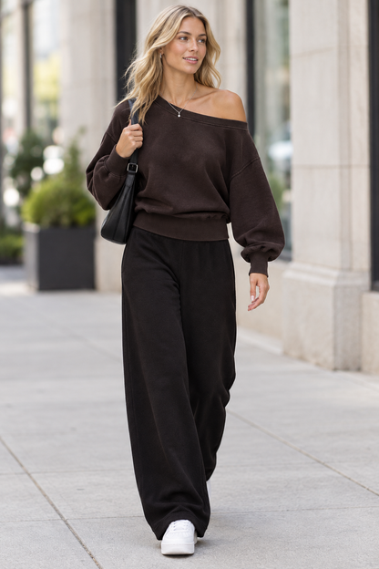 Blonde model wearing the reference sweatshirt walking on a city sidewalk